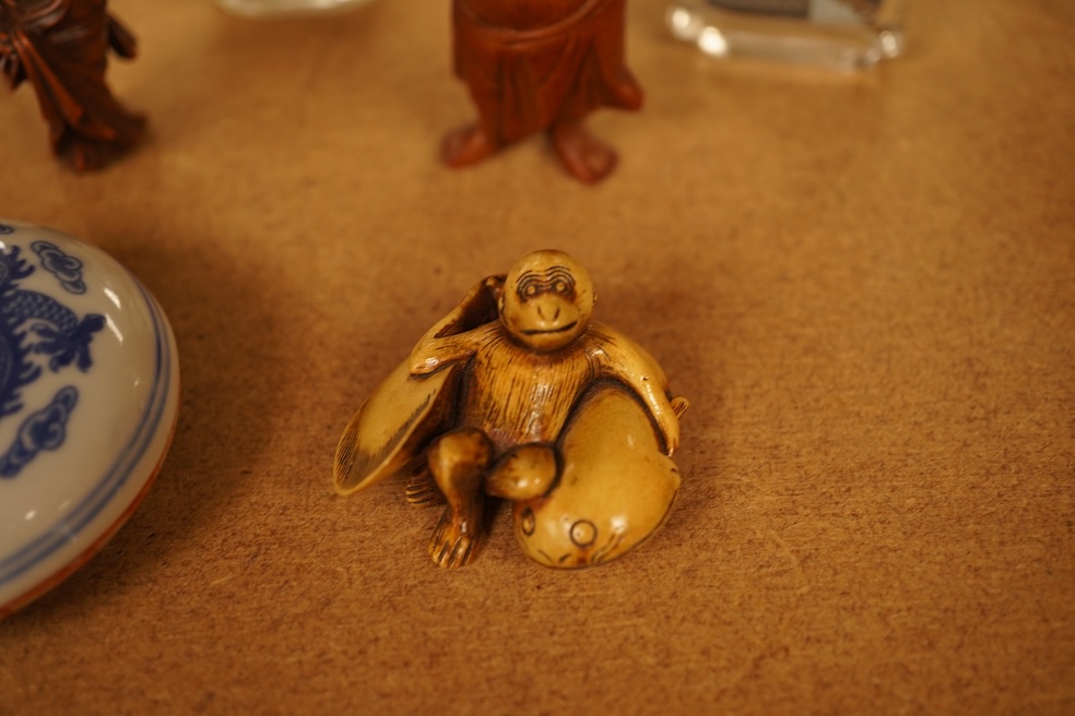 A collection of Chinese and Japanese items comprising snuff bottles, blue and white seal box and netsukes, largest 9cm high